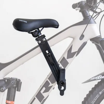 A child's bike seat attached to the frame of a mountain bike.