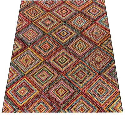 A close-up, angled view of a colorful, geometric patterned rug.