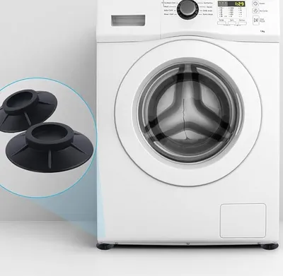 A washing machine with anti-vibration pads shown in the foreground.
