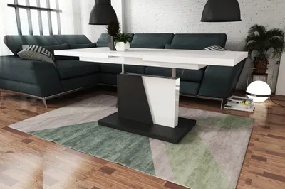 A modern living room with a sectional sofa, a coffee table, and a rug.