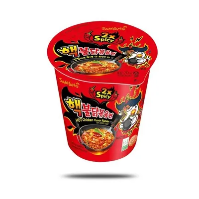 A product shot of a cup of Samyang Buldak Ramyun 2x Spicy instant noodles.