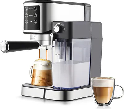 A close-up studio shot of a silver and black electric espresso machine with a glass carafe of coffee and a glass mug of latte in the foreground.