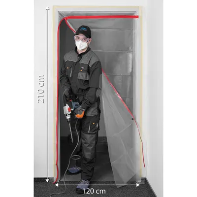 A person in protective gear stands in a doorway covered by a transparent plastic sheet with red tape, holding a drill.