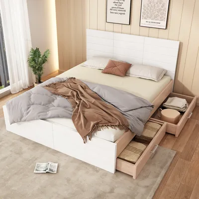 A bedroom scene featuring a white wooden bed with storage drawers, bedding, and a throw blanket.