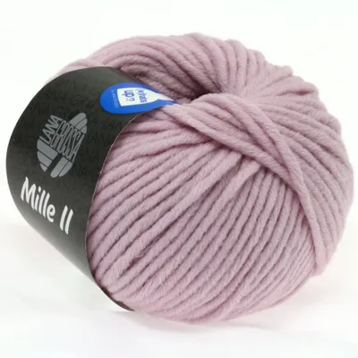 A ball of pink yarn with a black label wrapped around it.