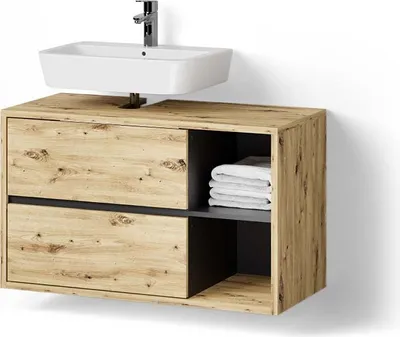 A bathroom vanity with a sink and faucet mounted above it, against a white wall.