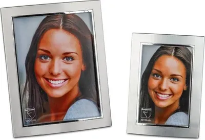 Two silver picture frames with photos of the same woman inside them, one larger than the other.
