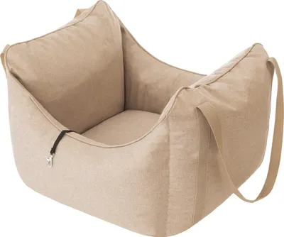 A beige pet bed with a strap on the side and a clip on the front.