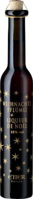 A bottle of Etter Weihnachtspflümli liqueur with gold star decorations on a white background.