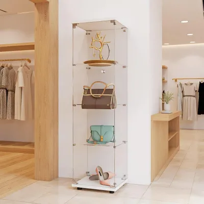 A display cabinet in a retail store setting, showcasing handbags and shoes.