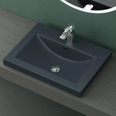 A close-up view of a modern, rectangular, matte anthracite washbasin with a chrome faucet and drain.