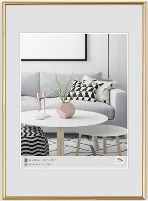 A framed picture of a living room scene with a sofa, coffee table, and decorative items.