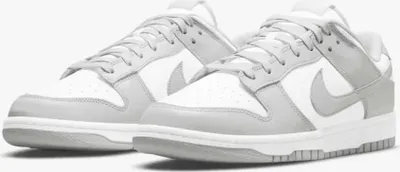 A pair of Nike Dunk Low Retro sneakers in white and grey fog.