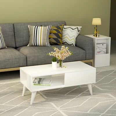 A living room scene with a couch, coffee table, and side table.