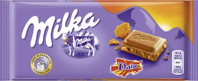 A Milka & Daim chocolate bar packaging with a piece of chocolate and caramel chunks shown.
