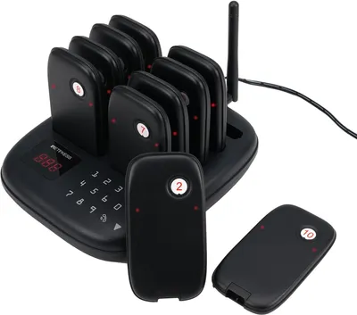 A black restaurant pager system with multiple pagers docked on a charging base, with two pagers in the foreground.