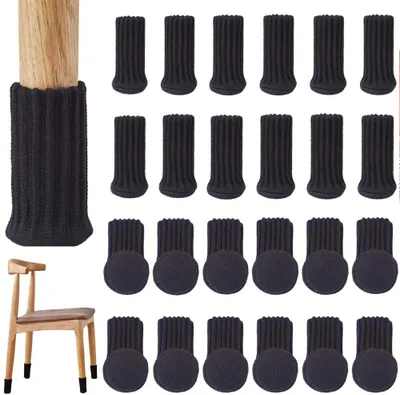 A collection of black knitted chair leg protectors, some shown on chair legs and some laid out in rows. A wooden chair with chair leg protectors on its legs is also pictured.