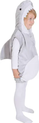 A young child wearing a shark costume.