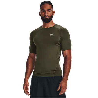 A man wearing a green t-shirt and black shorts, posing against a white background.
