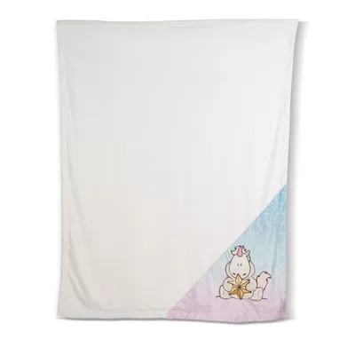 A flat lay of a white blanket with a cartoon unicorn graphic in the bottom right corner.