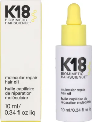 A product shot of K18 Molecular Repair Hair Oil, showing both the box and the bottle.