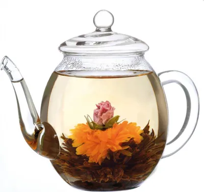 A glass teapot with a blooming tea flower inside, filled with tea.