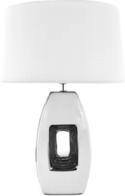 A white ceramic table lamp with a silver cutout.