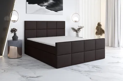 A modern bedroom with a brown boxspring bed.