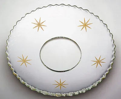 Produktbild von Glas-Kerzenmanschette - Tropfenfänger für Kerzen bis Ø 25 mm. Der Außendurchmesser der Kerzenmanschette beträgt Ø 70 mm. Hergestellt in Handarbeit aus klarem Glas. Das Ornament wird aus 21-karätigem Gold gefertigt. Schützt vor herablaufendem Wachs auf Ihrem gedeckten Tisch.