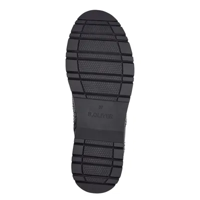 The sole of a black shoe is shown against a white background.