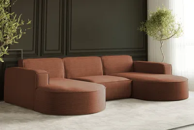 A modern sectional sofa in a living room setting with decorative wall paneling and a potted plant.