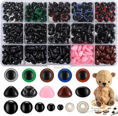 A collection of craft safety eyes and noses in various colors and sizes, neatly organized in a clear plastic case. A small teddy bear is placed to the right of the case, showcasing the use of the craft supplies.