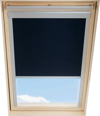 A dark roller blind is partially covering a skylight, revealing a blue sky with clouds below.