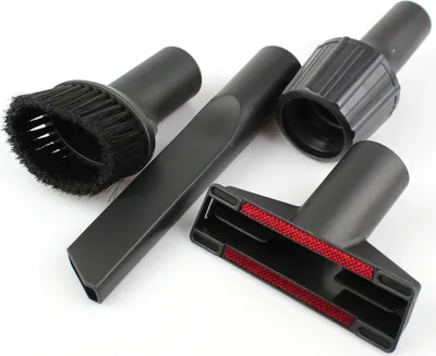 A set of four black vacuum cleaner attachments are arranged on a white background. The attachments include a brush head, a crevice tool, a universal nozzle with red inserts, and an adapter piece.