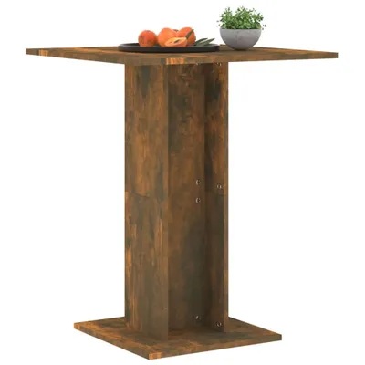 A square wooden table with a pedestal base, shown against a white background. A plate of fruit and a small potted plant are on the table.