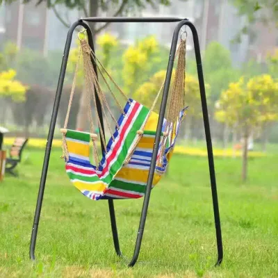 A hammock chair stand with a striped hammock in a grassy outdoor setting.