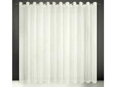 A white sheer curtain hanging on a rod against a dark gray wall.