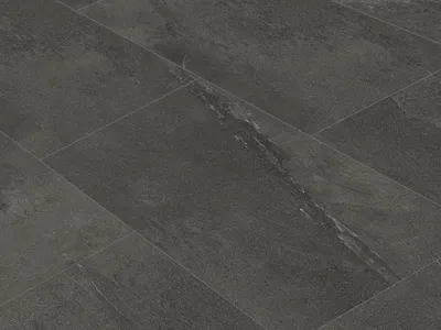 A close-up view of dark slate-look vinyl tiles laid diagonally.