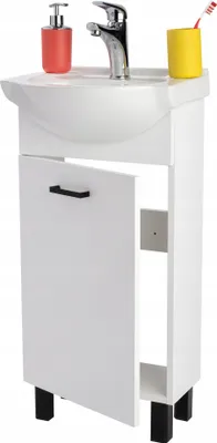 A white bathroom vanity with a sink and faucet, a soap dispenser, and a toothbrush holder.