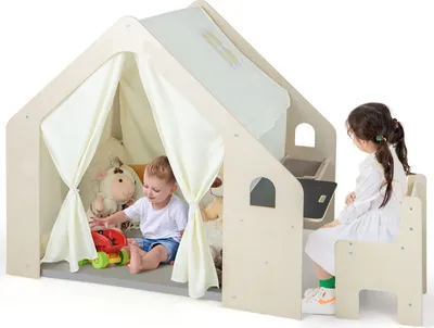 Two children playing inside a wooden playhouse.
