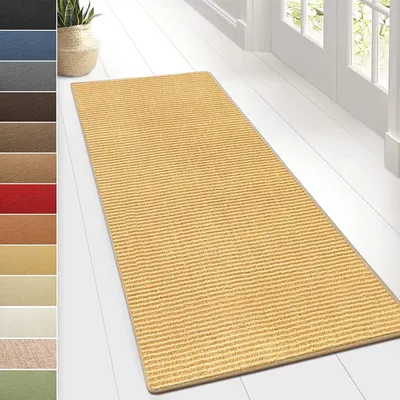 A yellow striped rug is laid out on a white wooden floor, with a plant in a basket visible in the background.