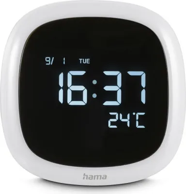 A white digital alarm clock with a black screen displaying the time, date, and temperature.