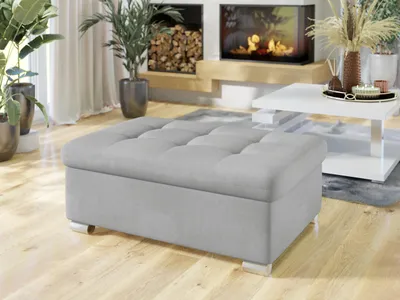 A modern living room with a fireplace, plants, and a coffee table.