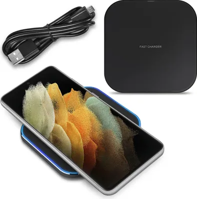 A wireless charger with a phone on it, and a charging cable.
