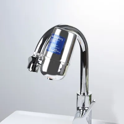 A close-up shot of a chrome faucet with a water filter attached.
