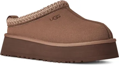 A single brown Ugg slipper with a platform sole is shown against a white background.
