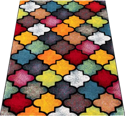 A colorful geometric patterned rug on a white background.