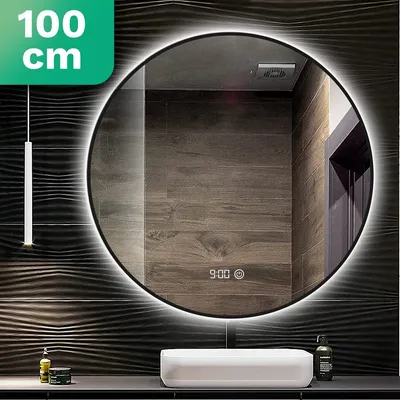 A round LED mirror is mounted on a wall with textured dark tiles. A white sink is below the mirror, and a pendant light hangs to the left.