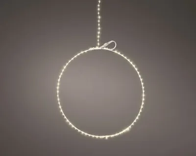 A circular light ring with warm white LEDs is suspended by a string.