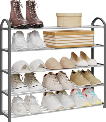 A multi-tiered shoe rack filled with various types of footwear, including boots, sneakers, sandals, and flats. Two storage boxes are also placed on the upper shelves.